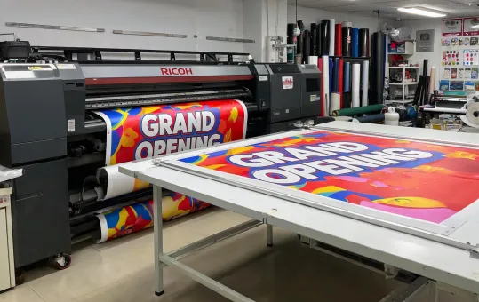 Wide format signage printer producing banners